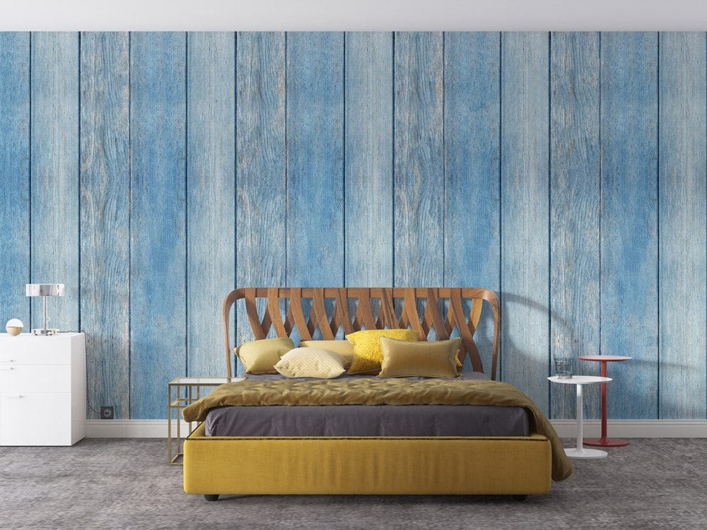 Vintage blue plank wallpaper with mustard bed, grey carpet, white dresser in modern bedroom.