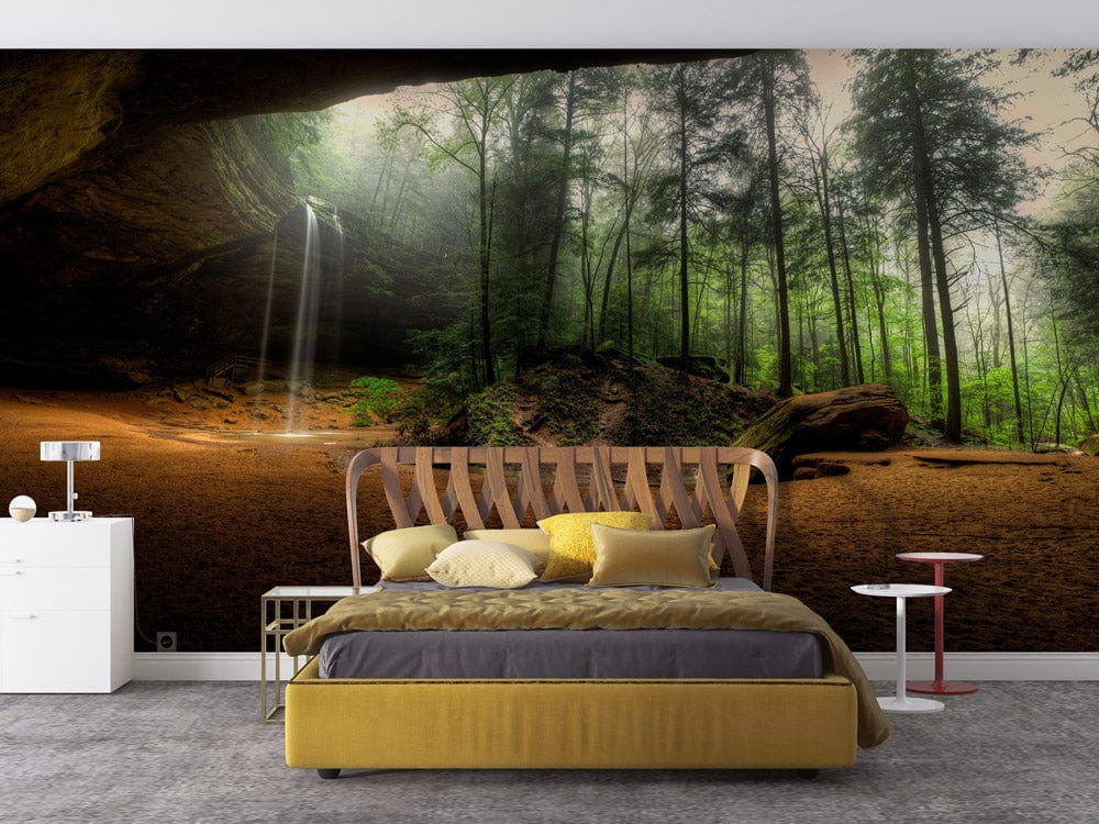Serene Forest Waterfall mural wallpaper in bedroom. Yellow bed, grey carpet, white and red side tables.