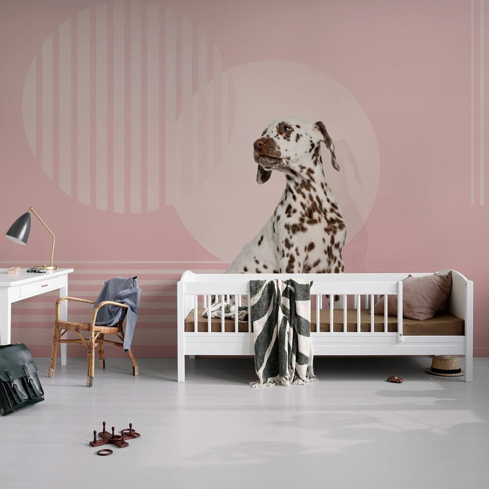 Pastel pink abstract circles wallpaper mural, Dalmatian motif, white child's bed, modern kid's room.