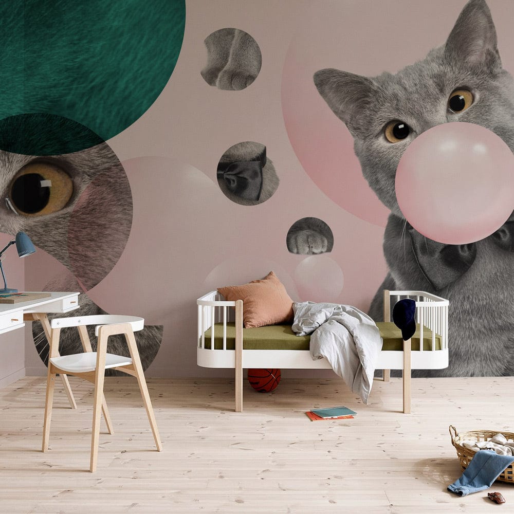 Playful grey cat wallpaper with pink, teal accents behind modern furniture in stylish living room setting.