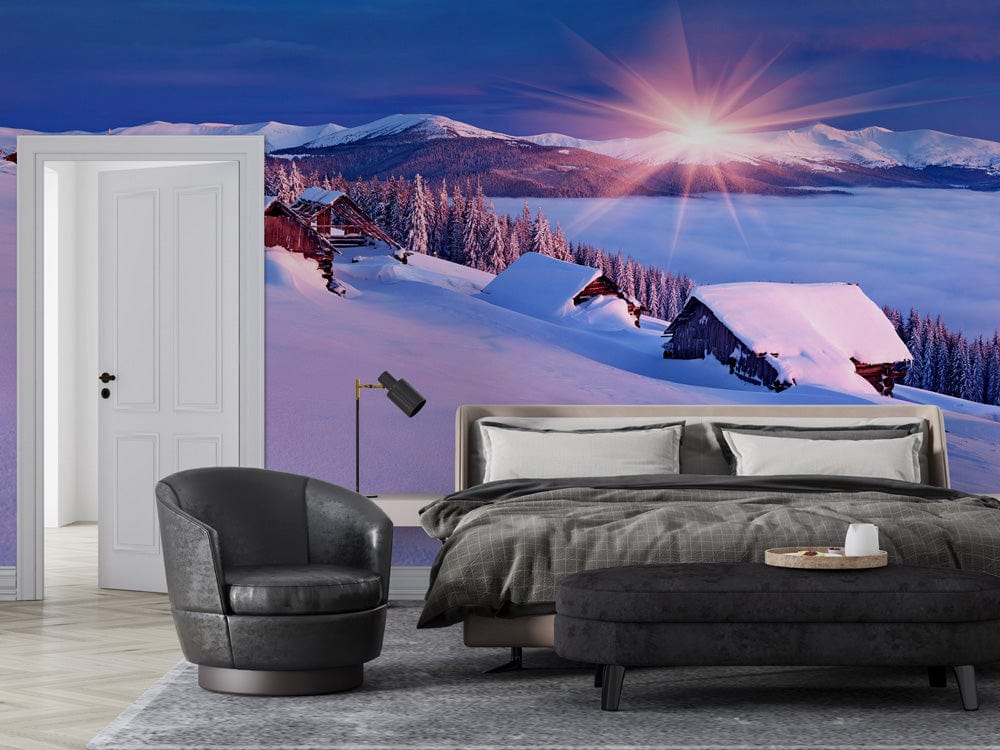 Sunset Alpine Winter Scene mural wallpaper with grey bed, black chair, and chevron flooring in bedroom.