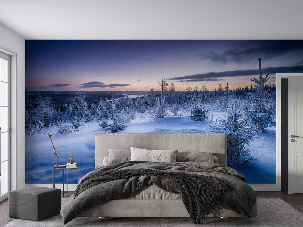 Majestic Winter Wonderland mural in icy blue hues, grey bed, modern bedroom, dark wood flooring.