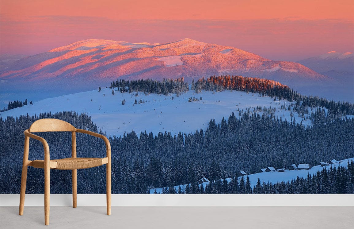 Sunset Mountain Serenity Mural Wallpaper in soft pinks, blues; wooden chair, grey flooring, scenic view.