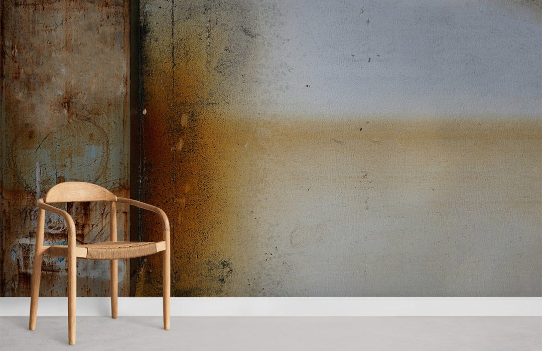 Wooden chair against rustic industrial wall mural in earthy metal tones, complementing minimalist decor.