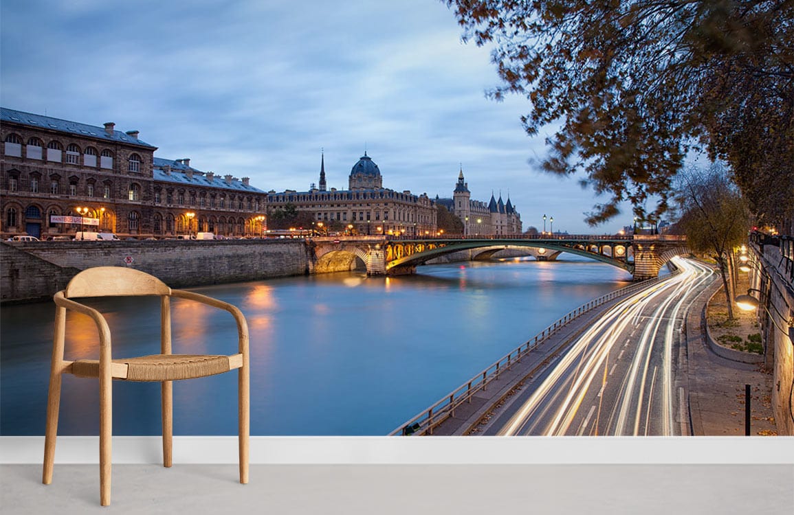 Elegant Paris River Scene Mural Wallpaper in blues, alongside modern wooden chair, light floor.