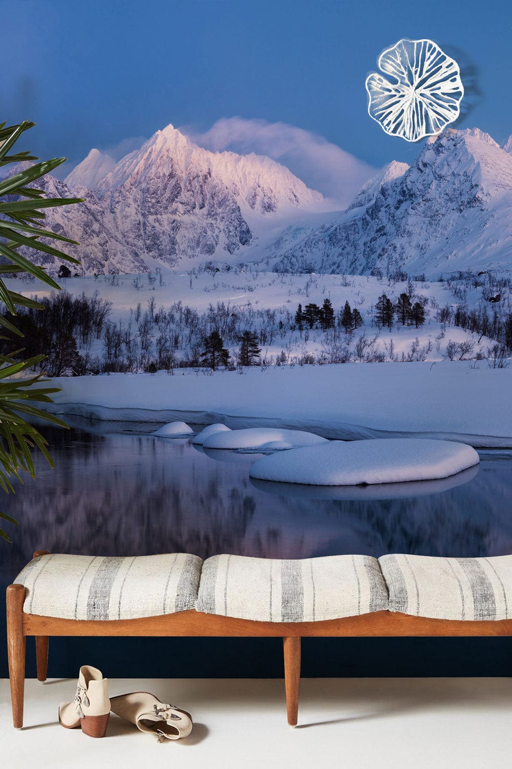 Serene snowy mountain wallpaper in blue tones, wooden bench, stylish beige upholstery, serene decor.