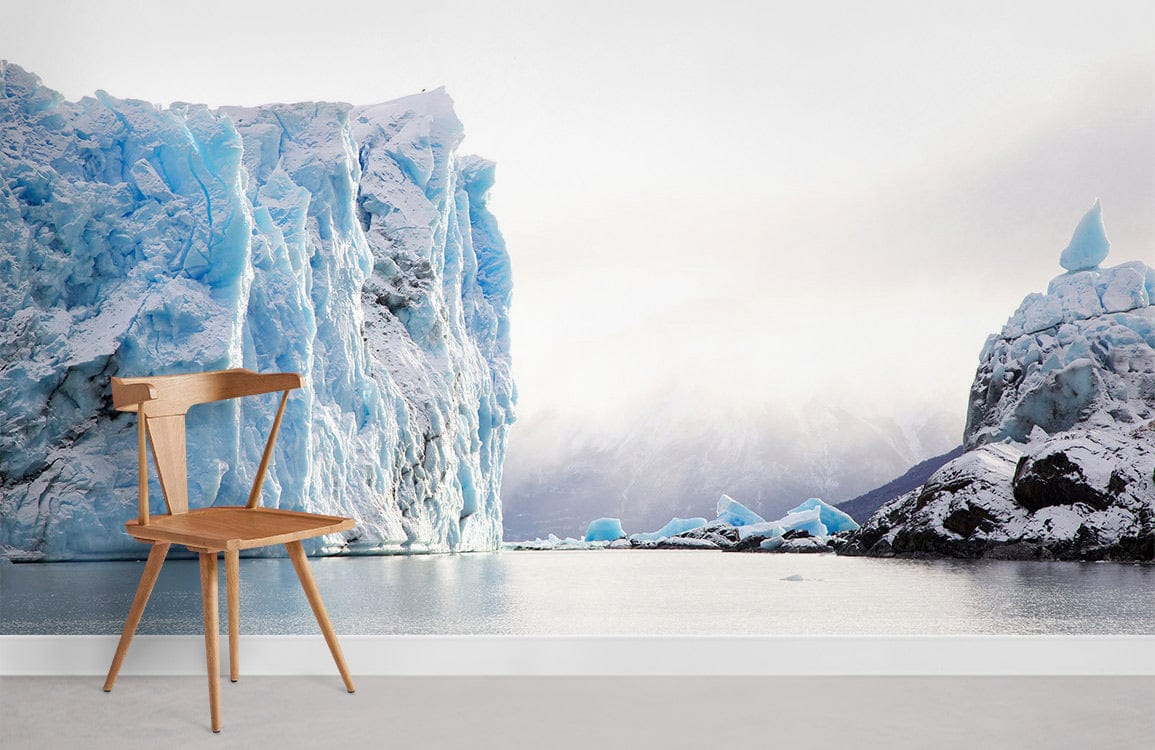 Serene Icy Landscape Mural Wallpaper with wooden chair in minimalist room setting, grey flooring.