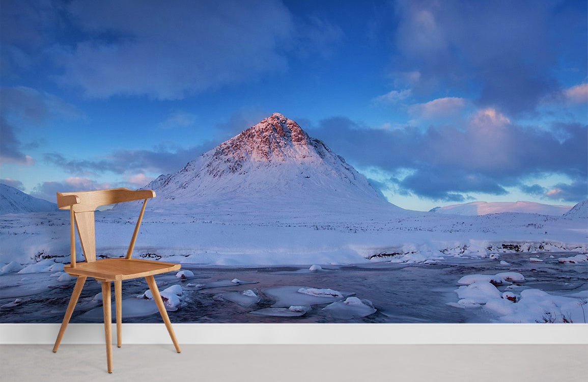 Chair in front of Serene Winter Mountain Landscape Mural Wallpaper; cool blues, snow-capped peaks, minimalist decor.