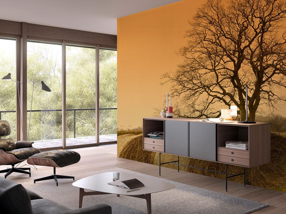 Rustic landscape mural wallpaper with tree scene in modern living room, grey sofa, wooden flooring.