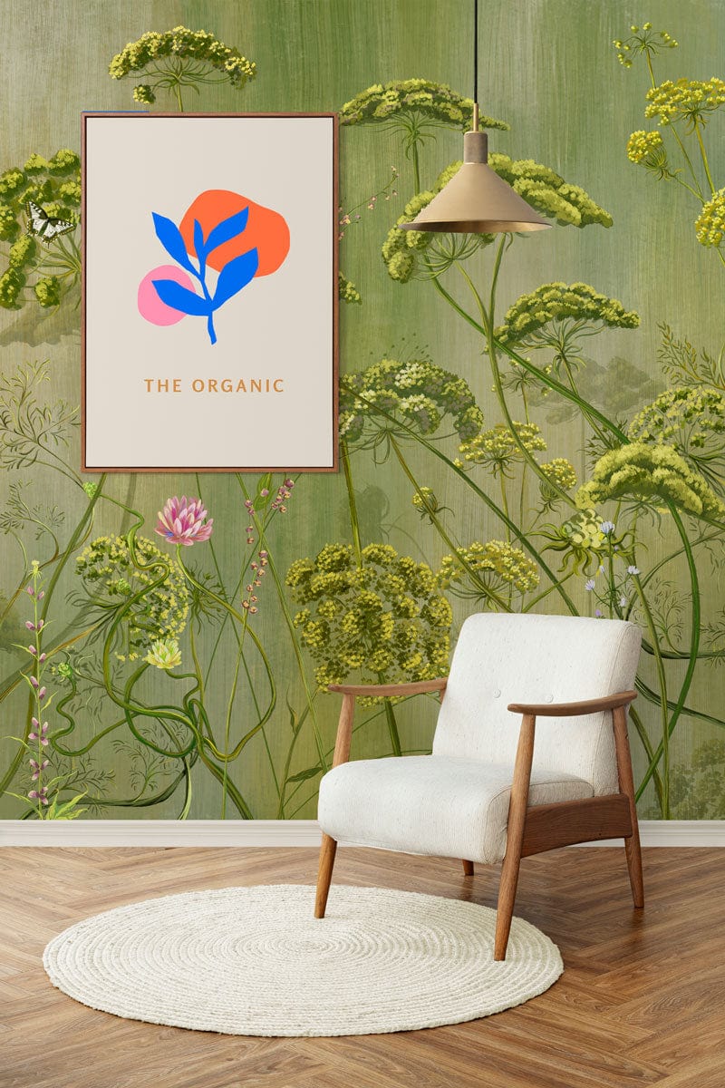 Botanical Garden Green Floral Mural Wallpaper in living room with white armchair, wooden flooring, artwork.