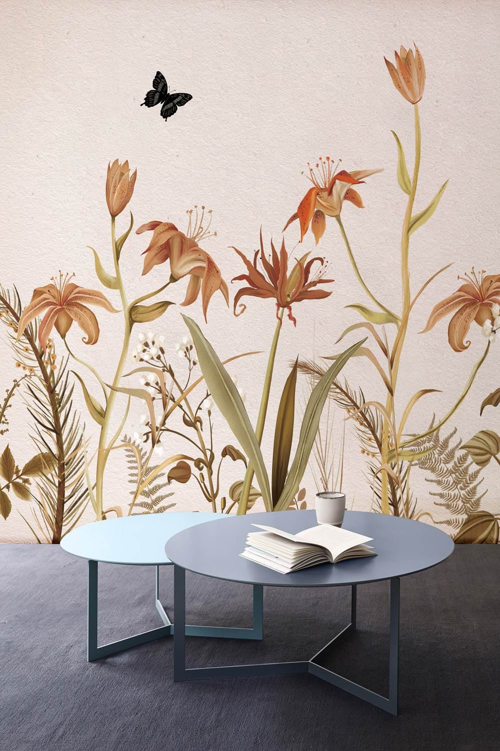 Vintage botanical flora mural wallpaper, neutral tones; butterflies; modern blue coffee table on dark flooring.