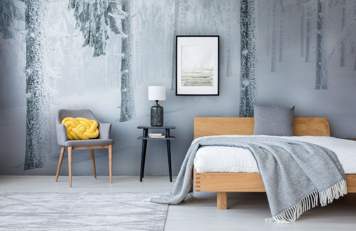 Snowy Winter Forest Mural Wallpaper with serene tones, wooden bed, grey chair, neutral rug.