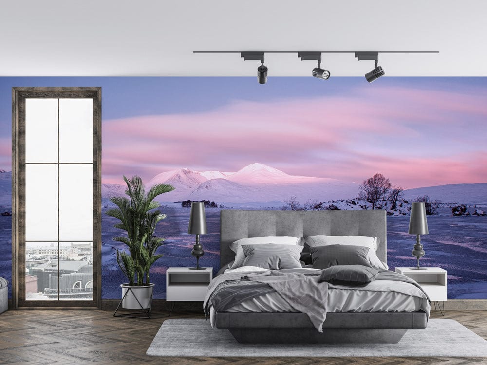 Tranquil mountain mural decor with grey bed, hardwood floor, modern bedroom setting, and stylish lighting.
