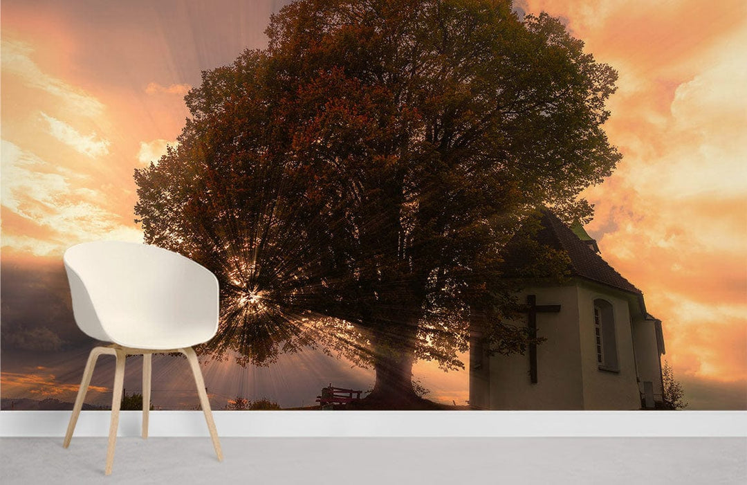 Tranquil sunset church mural with tree, white chair, minimalistic room style, autumn glow ambience.