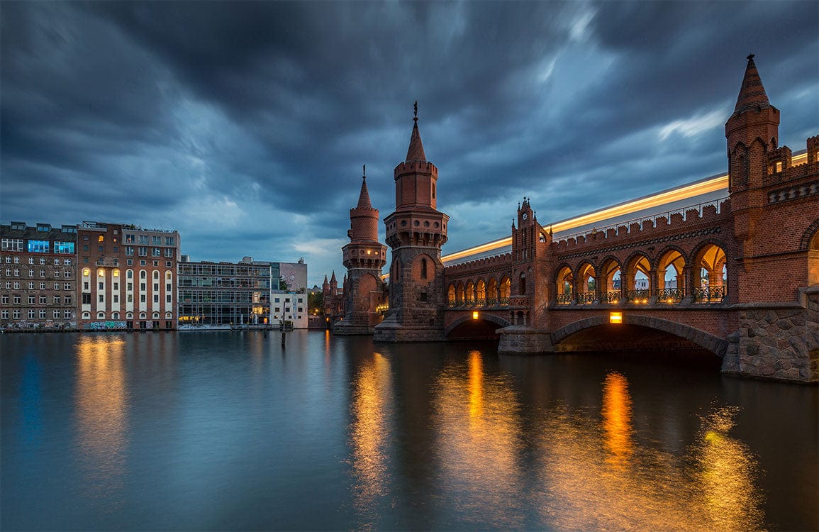 Serene Evening Cityscape Mural Wallpaper - Dramatic Skies over Historic Bridge