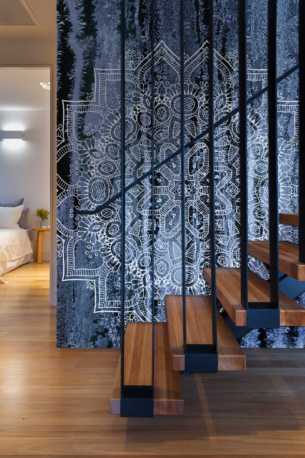 Mystical Midnight Blue Mandala Wallpaper in staircase, featuring intricate abstract design and wooden steps.