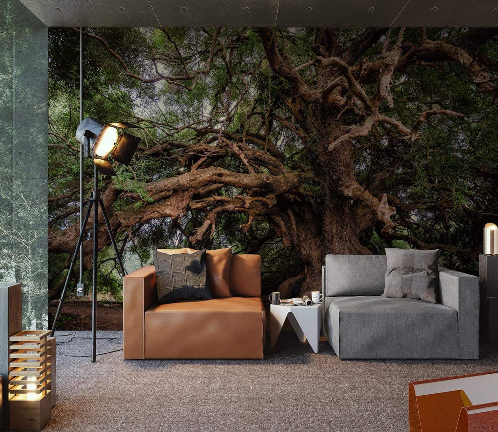 Majestic tree mural wallpaper, earthy tones, modern living room, leather armchair, grey sofa, carpet flooring.