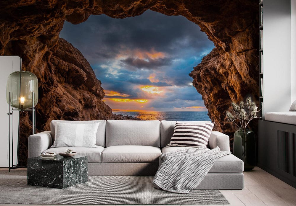 Stunning ocean cave mural in vibrant coastal colours, featuring grey sofa and marble side table.