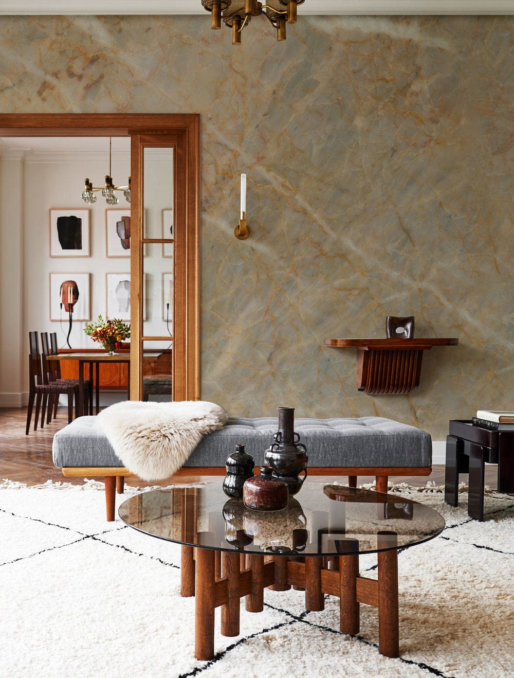 Elegant Natural Stone Effect Wallpaper in a living room with grey sofa, wood table, marble wall.