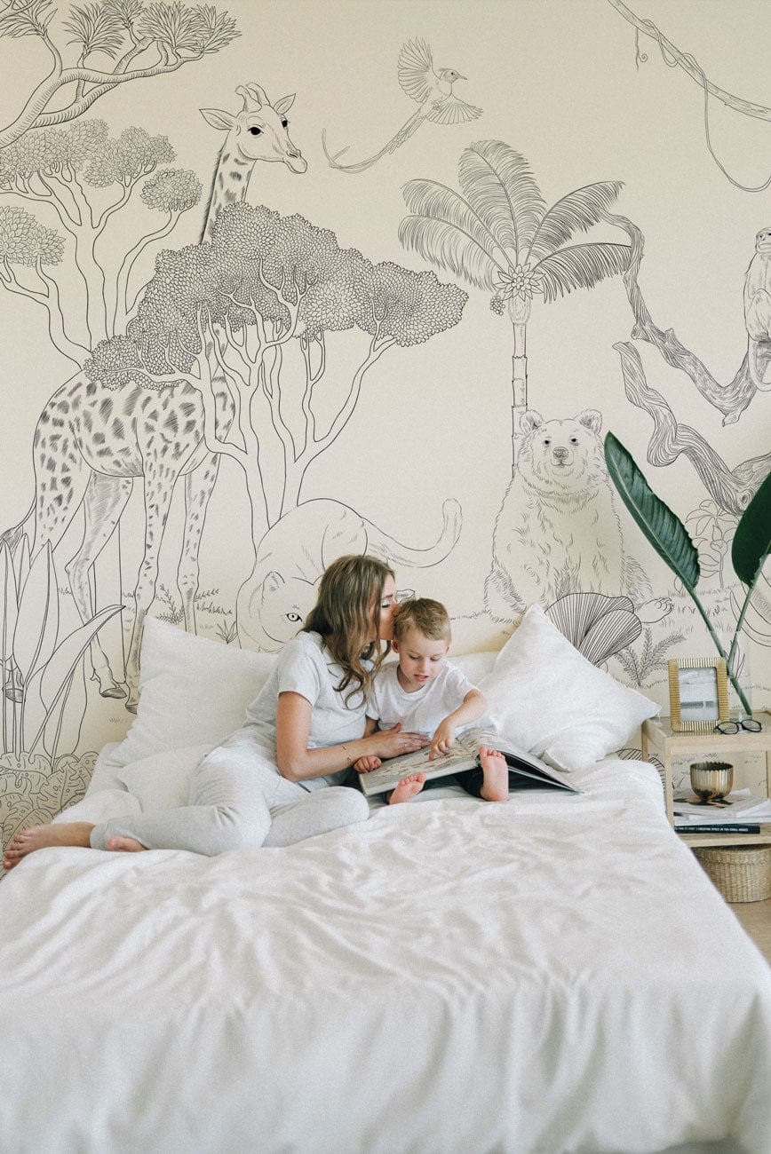 Monochrome Safari Wildlife Mural Wallpaper in bedroom with elegant jungle sketch, white bed linens.