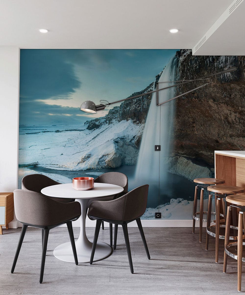 Serene Winter Waterfall Mural Wallpaper, dining room, modern chairs, light wood flooring, wall lamp.