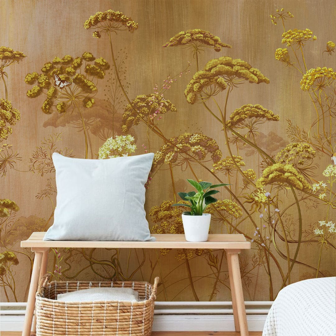 Golden Botanical Meadow Mural Wallpaper, vintage floral design, features wooden bench, cushion, rattan basket.