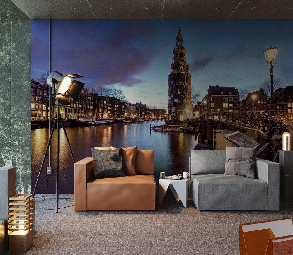 Amsterdam Canal mural wallpaper in modern living room with brown leather sofa, grey armchair, cosy lighting.