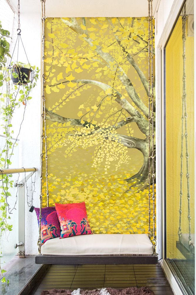 Golden Autumn Tree Mural Wallpaper adorns balcony with cushions, swing seat, hanging plants, wooden flooring.