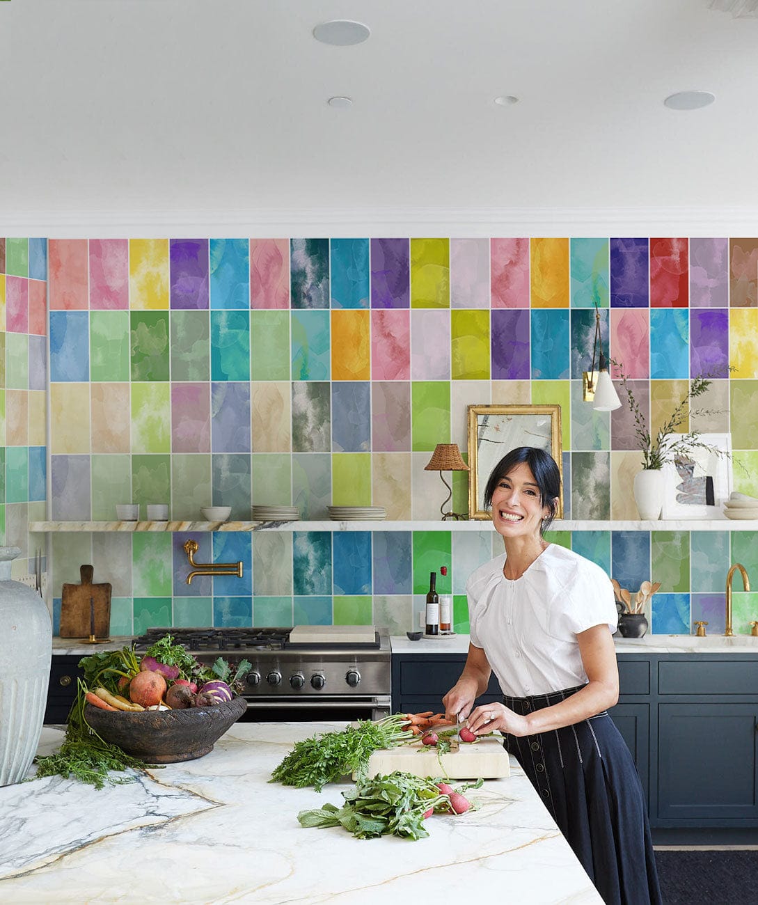 Vibrant watercolour pastel mosaic kitchen mural with marble worktop, modern appliances, and dark cabinetry.