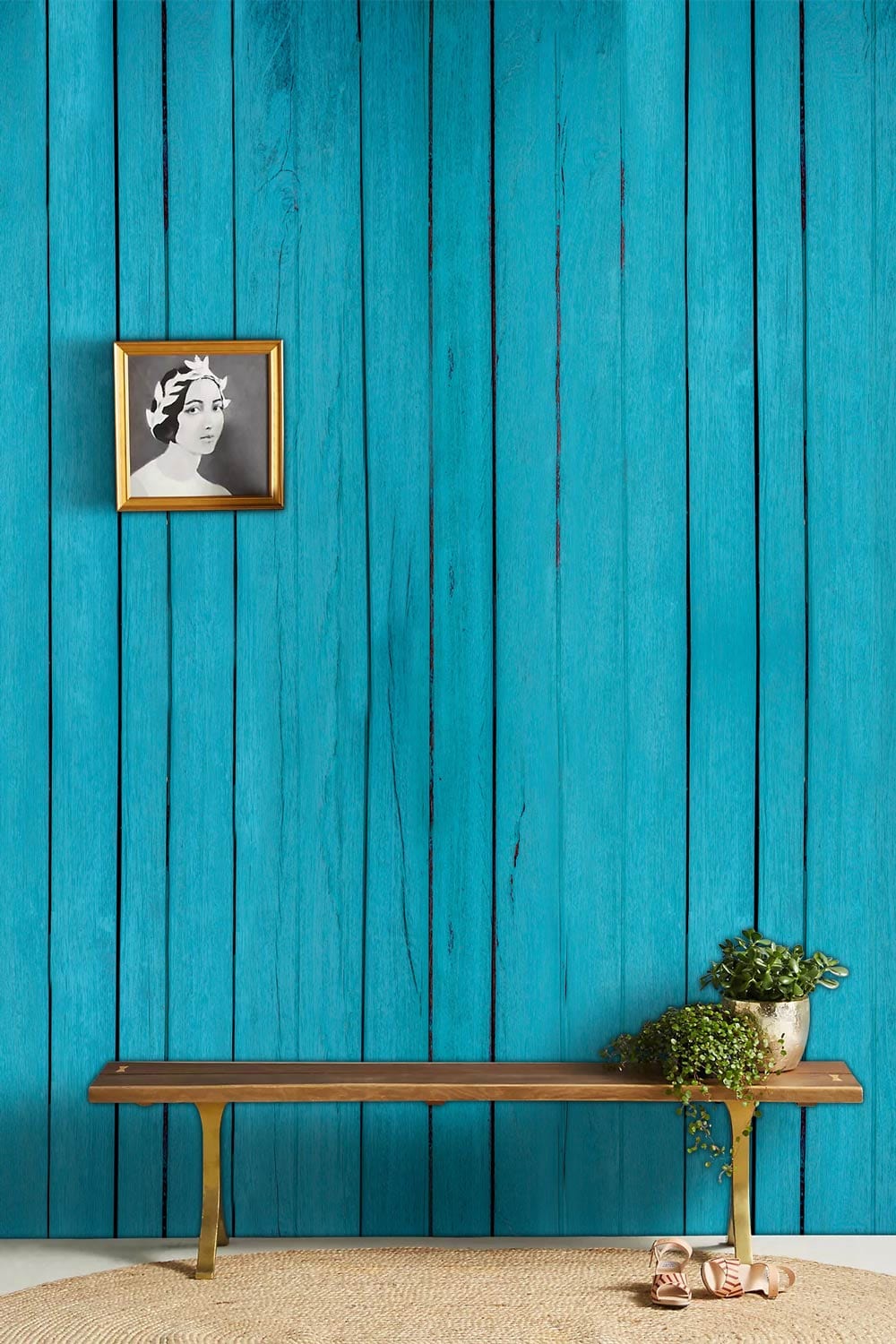 Rustic turquoise wooden plank wallpaper in coastal decor with wooden bench and framed artwork detail.