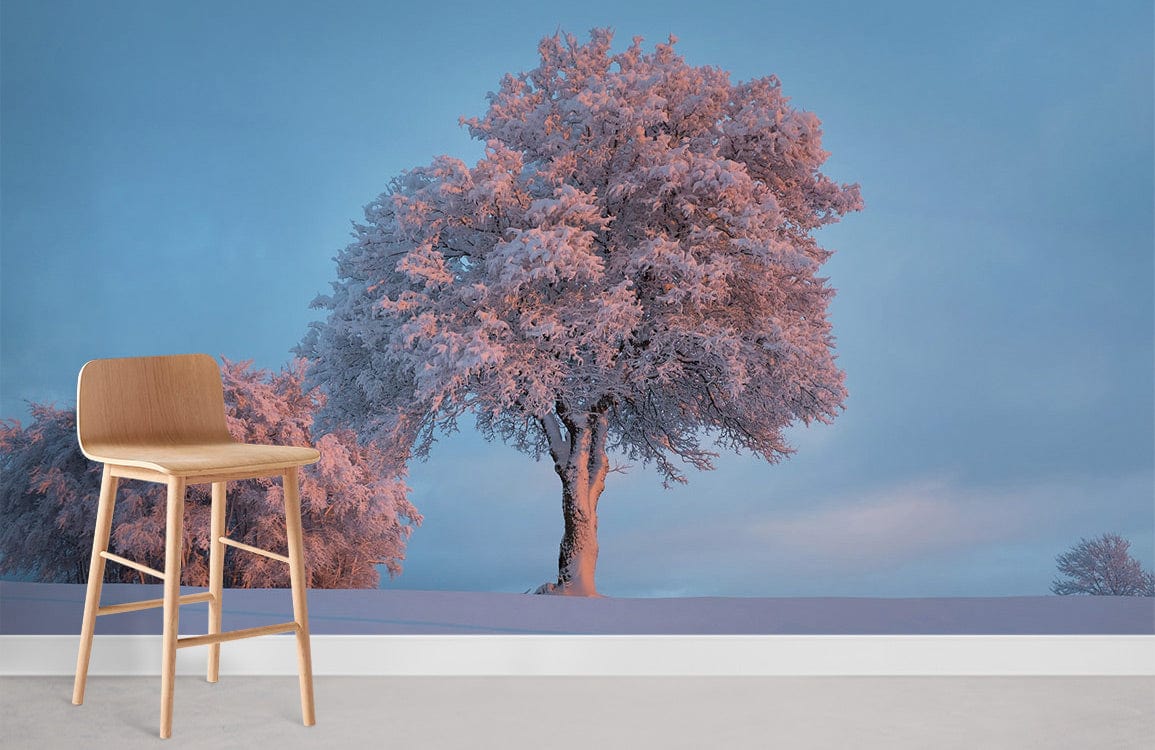 Elegant frosty winter tree mural with soft blue tones, wooden bar stool, minimalist room aesthetic.