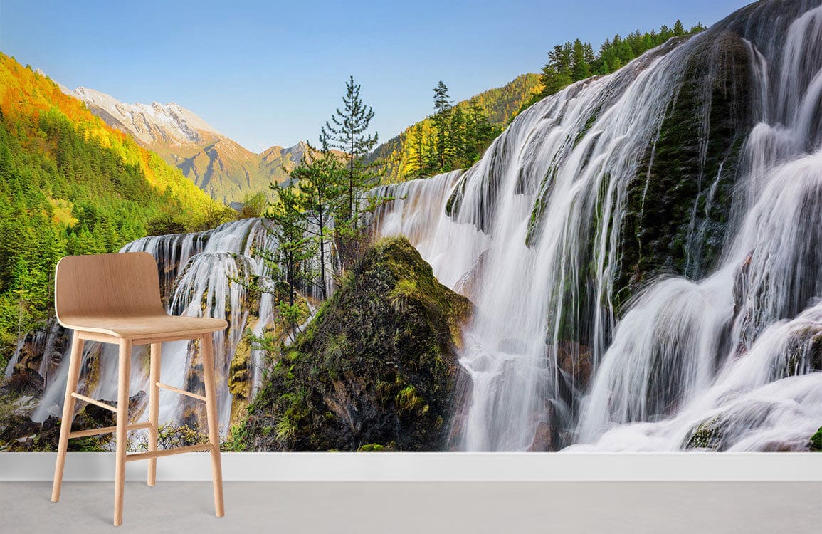 Serene Waterfall Mural Wallpaper in living room with wooden chair and grey flooring, nature Décor.