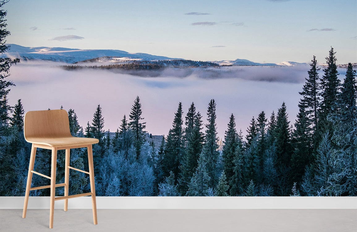 Mist-covered forest mural wallpaper with frosty mountain design; wooden stool, minimalistic modern room setting.