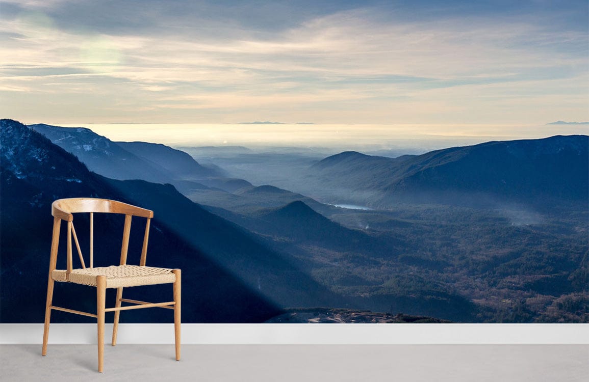 Tranquil Mountain Vista Mural Wallpaper, serene blue tones, wooden chair, grey flooring, modern decor.