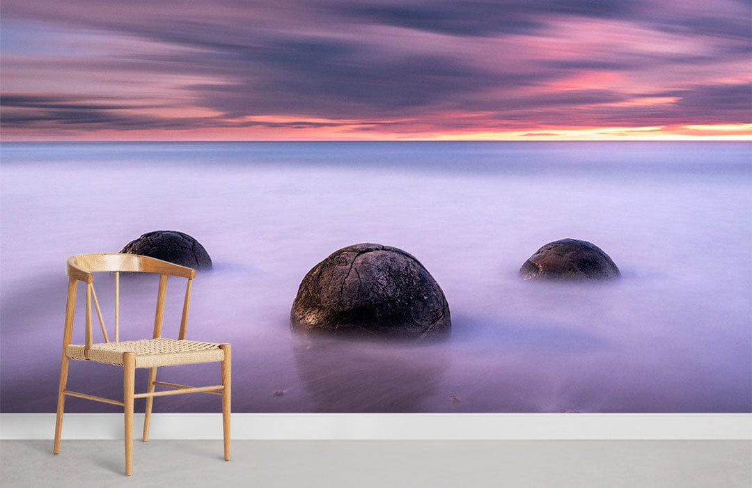 Ethereal Coastal Sunset Mural Wallpaper, serene purple ocean scene, wooden chair, grey flooring.