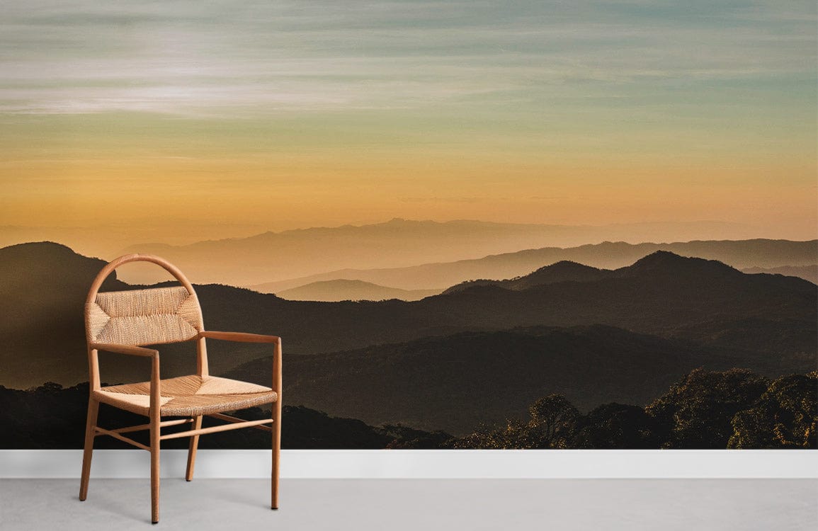 Golden Sunset Mountain Landscape Mural Wallpaper with wooden chair; serene nature decor, light flooring.