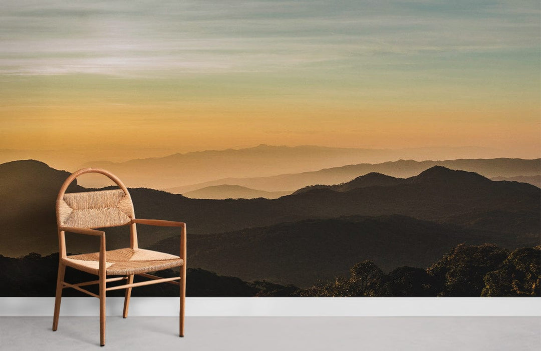 Golden Sunset Mountain Landscape Mural Wallpaper with wooden chair; serene nature decor, light flooring.