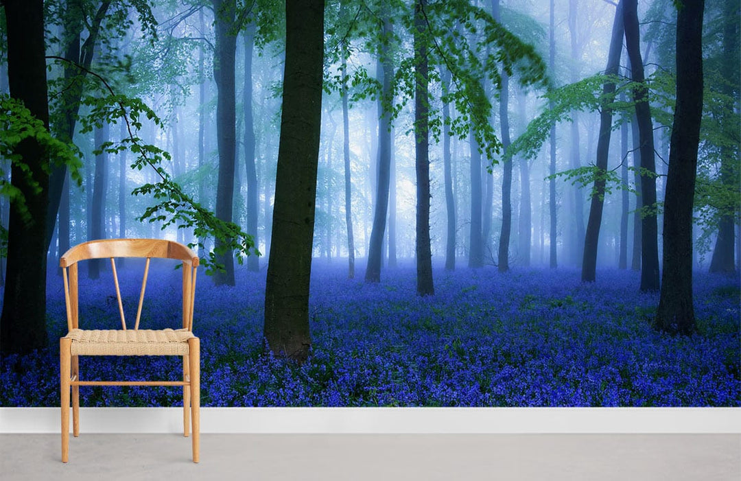 Chair with Enchanting Bluebell Woodland Mural Wallpaper, misty forest scene, and grey flooring in room.