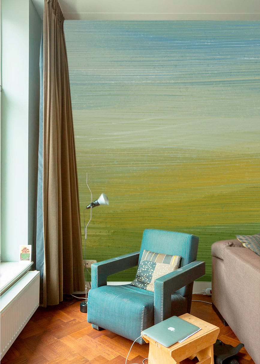 Serene Landscape mural wallpaper with blue-green gradient, teal armchair, brown sofa, and wooden floor.