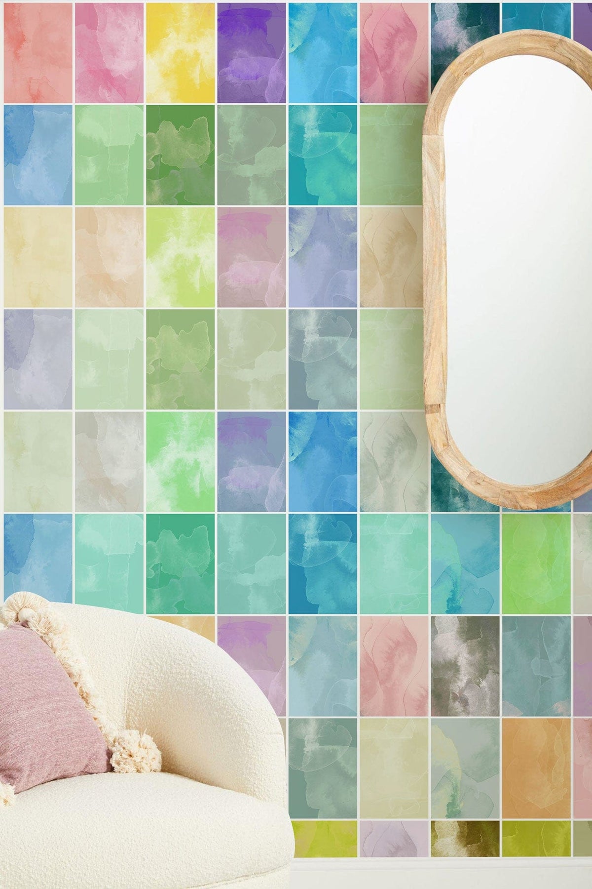 Colourful mosaic wall mural with modern beige sofa, wooden mirror, and vibrant watercolour pastels.