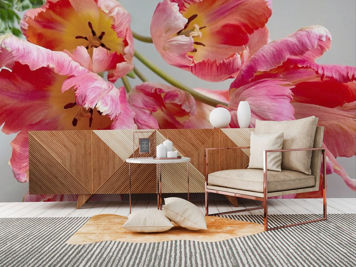 Vibrant pink tulip mural wallpaper in modern living room with geometric sideboard and beige armchair.