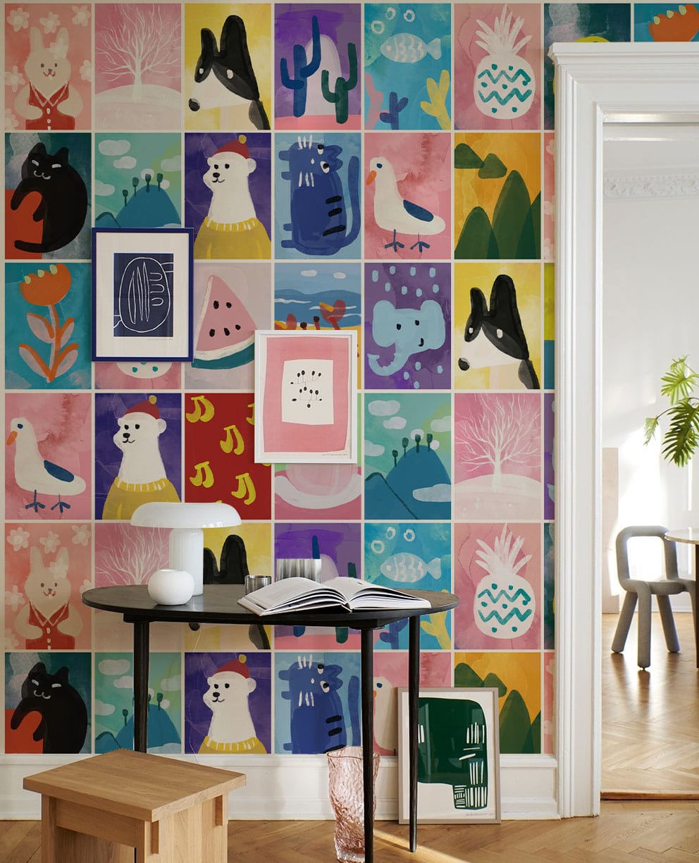 Colourful animal patchwork pattern wallpaper in kids' room with minimalist furniture and wood flooring.