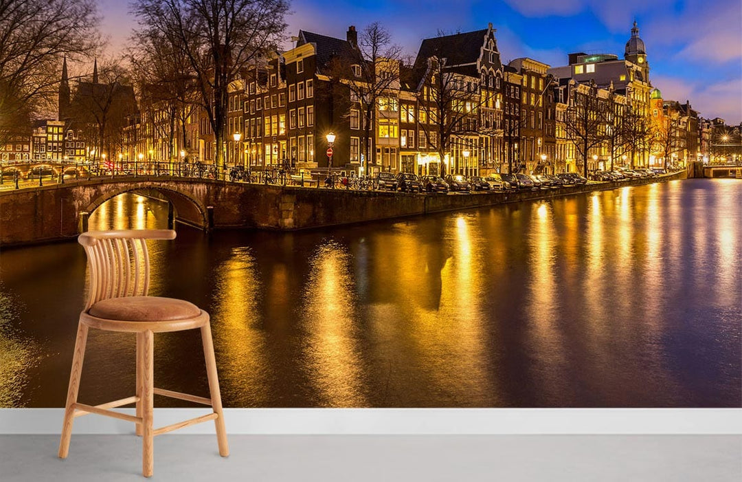 Amsterdam canal mural wallpaper with evening glow, featuring wooden bar stool, urban warm landscape design.