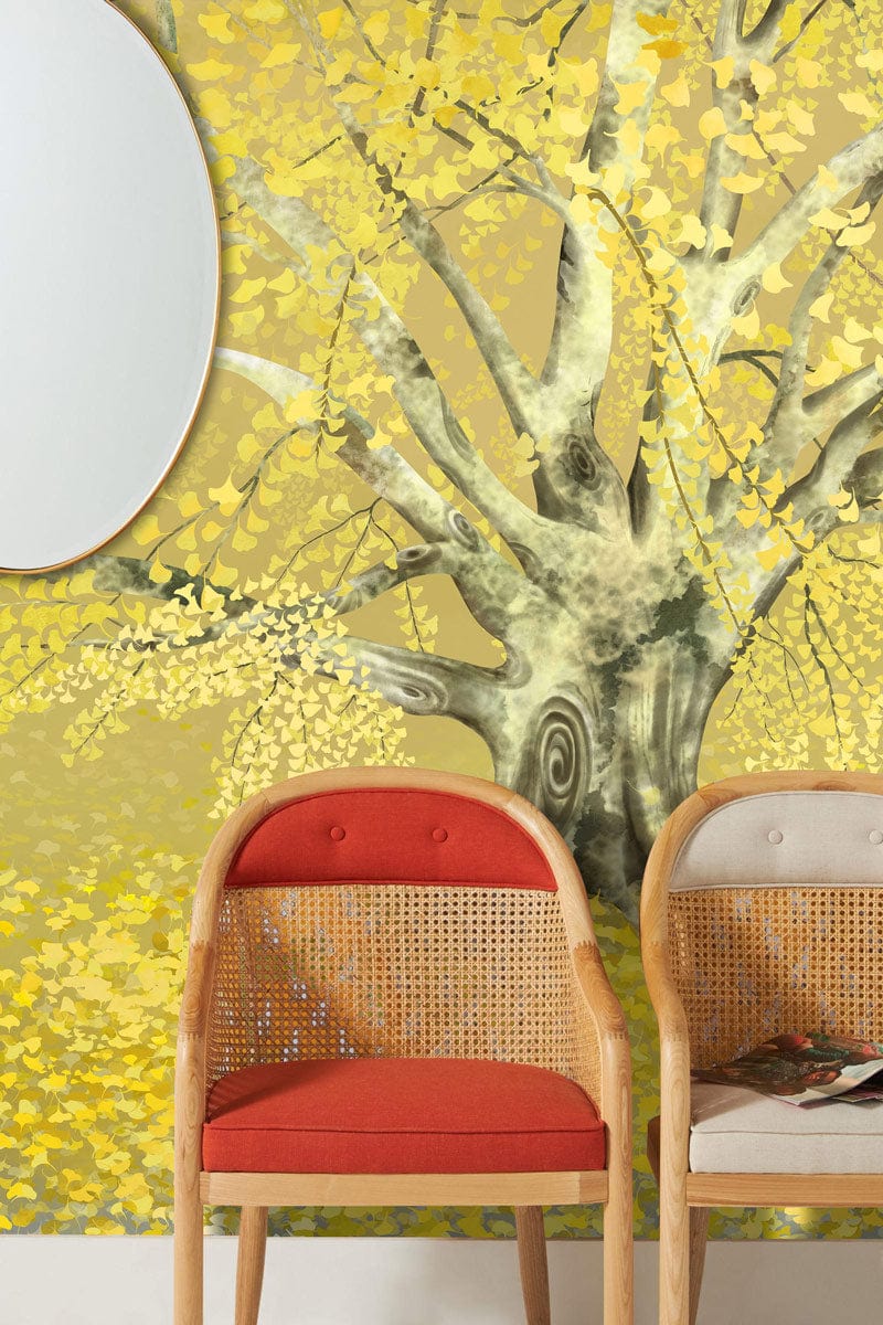 Golden Autumn Tree Mural Wallpaper in room with wicker chairs, round mirror, nature-inspired decor.