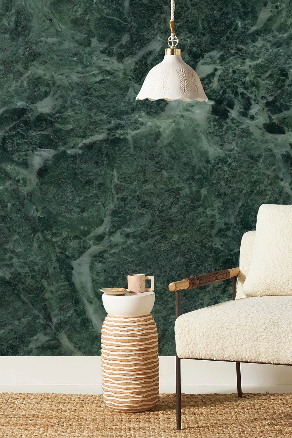 Luxurious Green Marble Effect Wallpaper with elegant armchair, woven rug, and stylish pendant light.