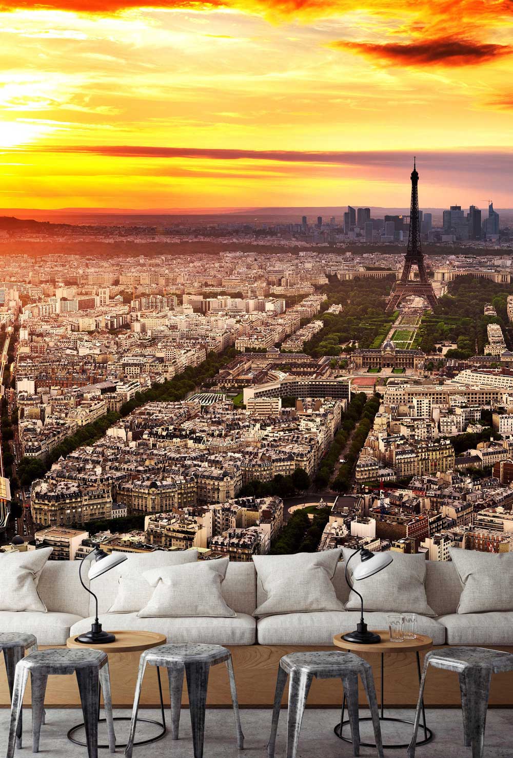 Paris Skyline Sunset Mural Wallpaper featuring Eiffel Tower; grey sofa, modern stools in living room.