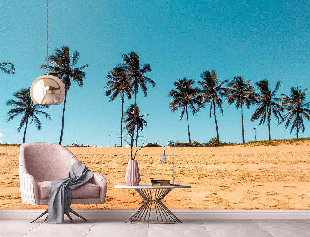 Tropical beach paradise mural with palm trees, pastel pink chair, round table in modern living room.