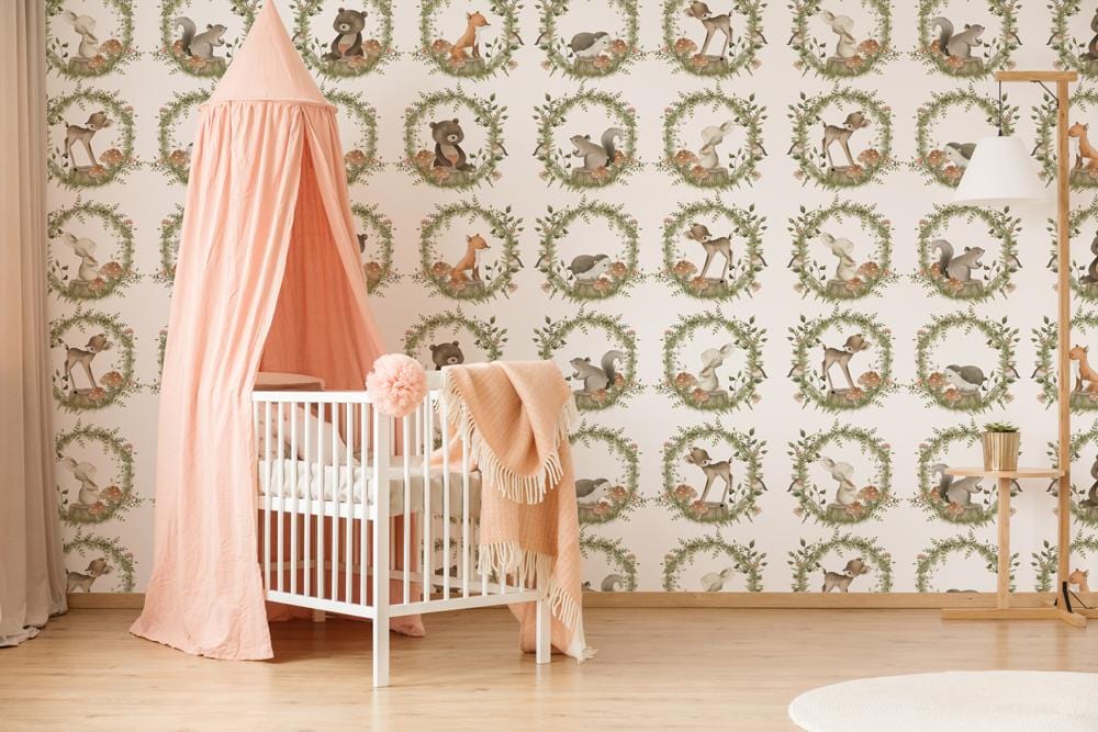 Charming Woodland Creatures wallpaper in nursery with peach canopy, white crib, light wood flooring.