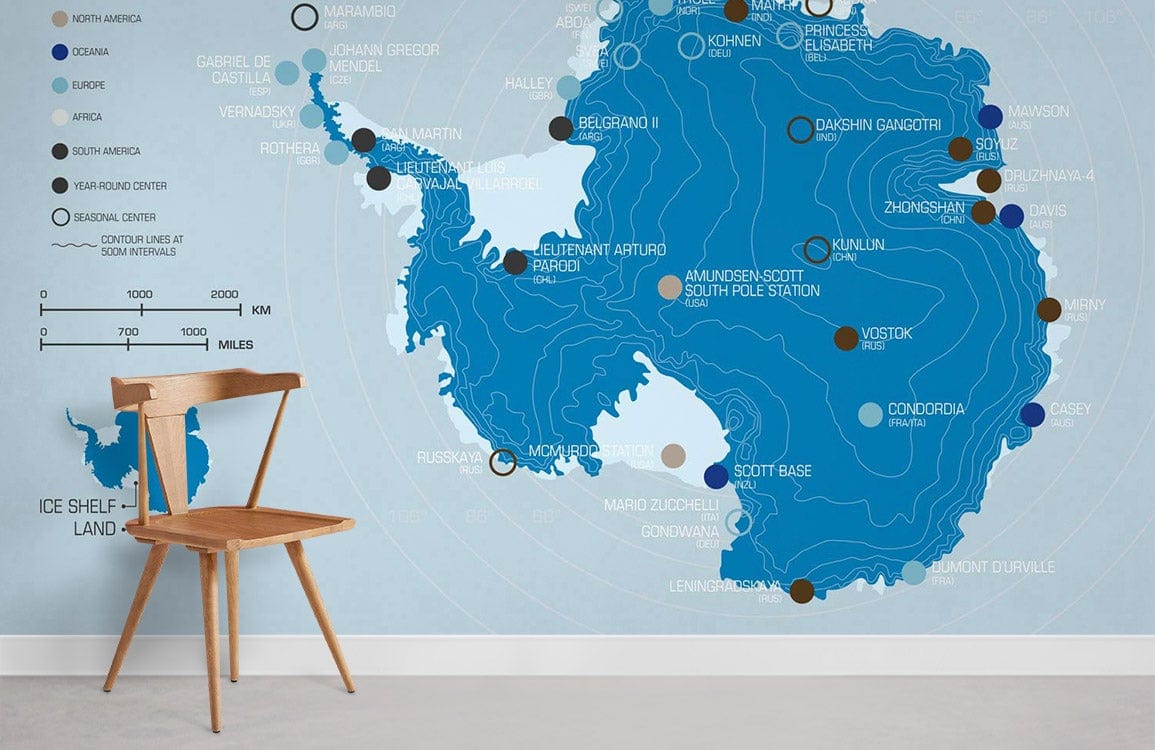 Elegant blue Antarctic map mural wallpaper with a wooden chair on light grey flooring in study room.