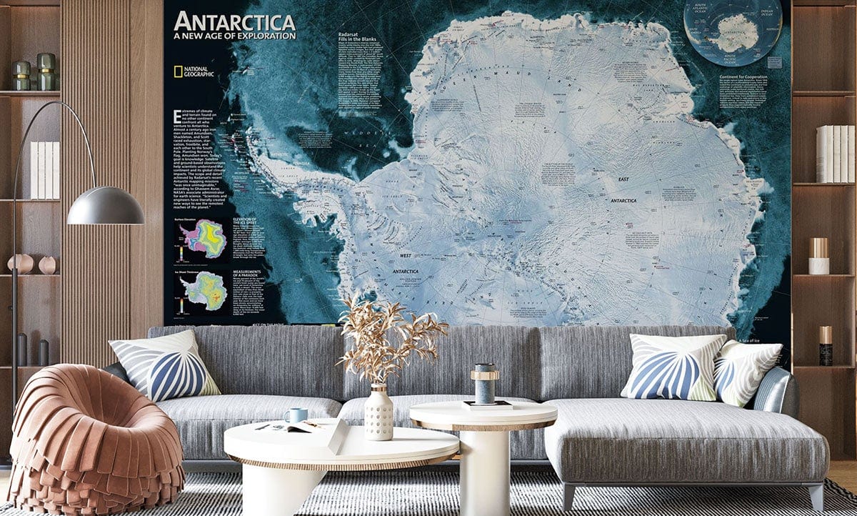 Antarctica Exploration Map Mural Wallpaper in blue adventure theme; grey sofa, wooden flooring, modern Décor.